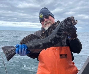 Happy angler with lingcod
